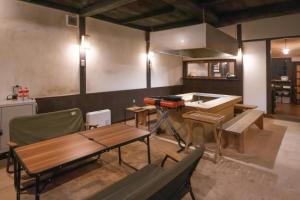 a room with a kitchen with a table and a counter at 田篭の灯り in Ukiha +7 photos