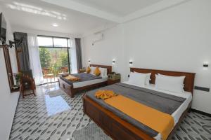 a bedroom with a bed and a couch in a room at Ivory Canopy Resort - Ella in Ella