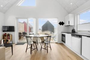 una cucina e una sala da pranzo con tavolo e sedie di 949-Hvide-Sande-Langsand-161 a Hvide Sande Altre 27 foto