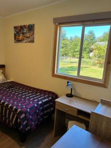 En eller flere senge i et værelse på Cabañas Cuatro Estaciones Frutillar Bajo