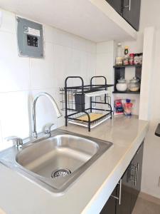 a kitchen counter with a sink and a shelf at Loft Rayito de Sol, Zihuatanejo Center with AC in Zihuatanejo +32 photos