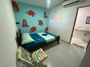 a small room with a bed and a chair at Fauna in Santa Marta