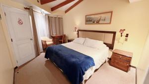 En eller flere senge i et værelse på Hotel Puerto Mayor