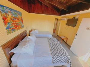 En eller flere senge i et værelse på Hotel Puerto Mayor