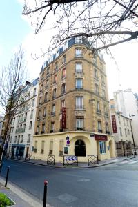 a large brick building on a city street at Au Fleuri hotel in Paris