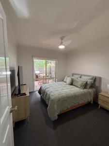 a bedroom with a bed and a television in it at The Terrace - Echuca in Echuca