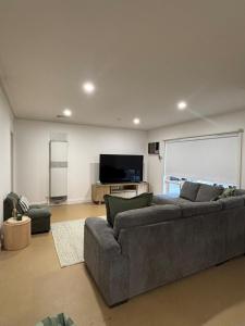 a living room with a couch and a flat screen tv at The Terrace - Echuca in Echuca
