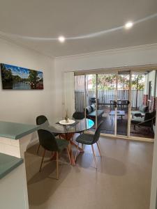 a living room with a glass table and chairs at The Terrace - Echuca in Echuca