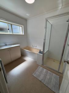 a bathroom with a shower and a sink and a mirror at The Terrace - Echuca in Echuca +10 photos