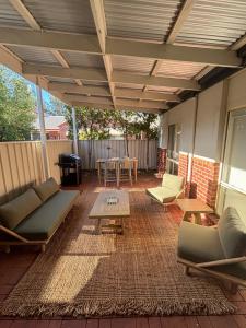 an outdoor patio with couches and a table at The Terrace - Echuca in Echuca