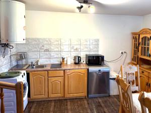 a kitchen with a sink and a stove at Domek Maria Mąka in Zakopane +10 photos