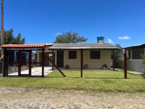 a house with a playground in front of it at Recanto do descanso in Pinhal