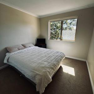 a bedroom with a large bed and a window at Live, Laugh, Lodge - Central 3x2 in Kalgoorlie