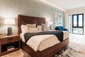 a bedroom with a large bed and a chair at Luxury Villa Retreat, Pool in Cabo San Lucas +28 photos