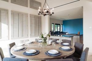 a dining room with a wooden table and chairs at Luxury Villa Retreat, Pool in Cabo San Lucas