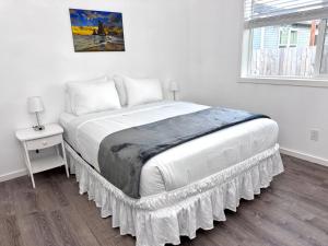 a bedroom with a large bed with a table and a window at Bogachiel Den in Forks