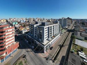 an aerial view of a city with buildings at Loft Central com garagem in Pelotas