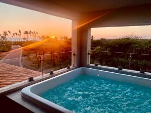 a hot tub in a house with a view of the sunset at CASA 1111 SMALL in Mazatlán