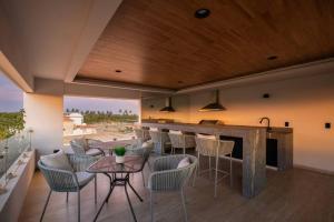 a bar in a room with chairs and a counter at CASA 1111 SMALL in Mazatlán