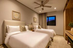 a bedroom with two beds and a ceiling fan at CASA 1111 SMALL in Mazatlán +19 photos