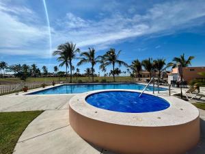 a large swimming pool with a large blue pool at CASA 1111 SMALL in Mazatlán