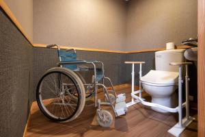 a wheelchair in a bathroom with a toilet at ShirabuOnsen Higashiya in Yonezawa +25 photos