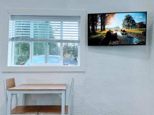 a picture hanging on a wall next to a window at The Sitka Studio in Forks