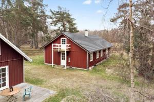 een rood huis midden in een bos bij 2315-Stege-Kongens-Enge-15 in Stege