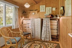 a room with wooden walls and chairs and a desk at 5011-Askeby-Faergensvaenge-17 in Askeby