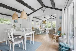 a dining room and living room with a white table and chairs at 3006-Stege-Bunden-6 in Stege