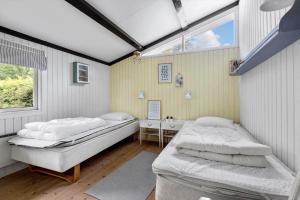 a room with two beds and a window at 3006-Stege-Bunden-6 in Stege