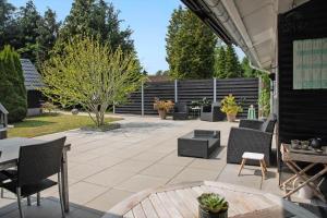a patio with chairs and tables and a fence at 3006-Stege-Bunden-6 in Stege +15 photos