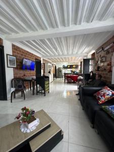 a living room with a couch and a table at Finca Cimarrones Robles 