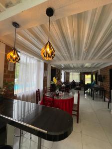 a living room with a table and chairs and a ceiling at Finca Cimarrones Robles 