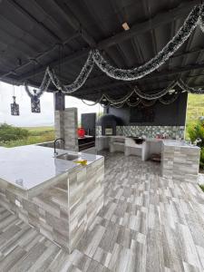 an outdoor kitchen with a table and a fireplace at Finca Cimarrones Robles 