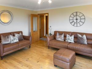 ein Wohnzimmer mit zwei braunen Ledersofas in der Unterkunft Trelaw - Uk41532 in Ochiltree + 21 Fotos