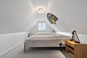 een witte slaapkamer met een bed en een raam bij FA004-Faxe-Ladeplads-Brandskov-4 in Fakse Ladeplads