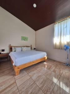 a bedroom with a bed in a room with a window at Monteverde Cecropia Paradise in Monteverde Costa Rica +8 photos