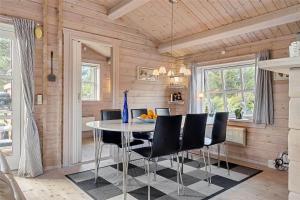 una sala da pranzo con un tavolo e sedie nere di FA035-Faxe-Ladeplads-Strandlodden-9 a Fakse Ladeplads Altre 14 foto