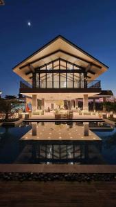 a large building with a pool in front of it at Amani Grand Resort Residences Pool Netflix Gym near Airport in Lapu Lapu City