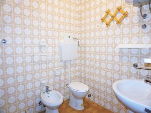 a bathroom with a toilet and a sink at Caorle Holiday Home with Terrace in Porto Santa Margherita di Caorle +29 photos