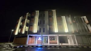 a large white building at night with its lights on at Brick Box Family Hotel Ipoh in Ipoh