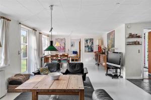 een woonkamer met een tafel en stoelen en een televisie bij 6318-Stege-Holtegardsvej-18-B in Stege