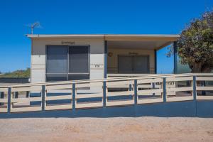 een huis met een hek ervoor bij Sunset Beach Holiday Park in Geraldton +60 foto's