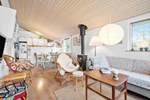 a living room with a couch and a table at R963-Rodvig-Skovstumperne-3 in Rødvig