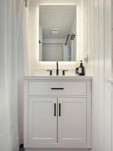 a white bathroom with a sink and a mirror at Dream Lakefront Escape + Beach/Ski/Golf near NYC in Highland Lakes +37 photos