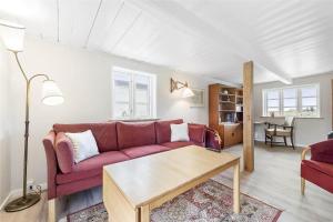 een woonkamer met een rode bank en een tafel bij FA009-Faxe-Ladeplads-Brandskov-6 in Fakse Ladeplads +16 foto's