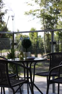 a table and two chairs on a porch with a table and chairs at U-Stay Bond Apartament in Kołobrzeg