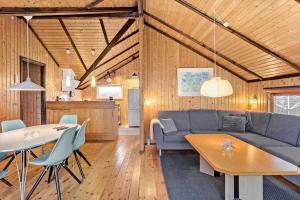 a living room with a couch and a table at 3078-Stege-Maegleren-18 in Stege