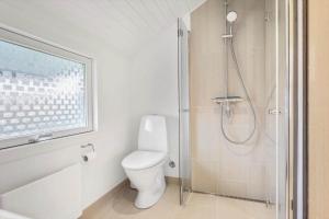 a bathroom with a toilet and a shower at 3078-Stege-Maegleren-18 in Stege +11 photos